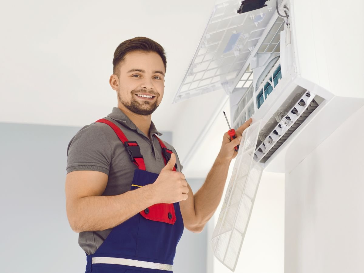 tech with thumbs up while installing